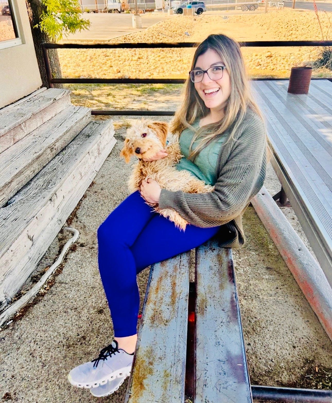 Woman in camouflage sweatshirt and leggings on a train, snowy mountain backdrop.