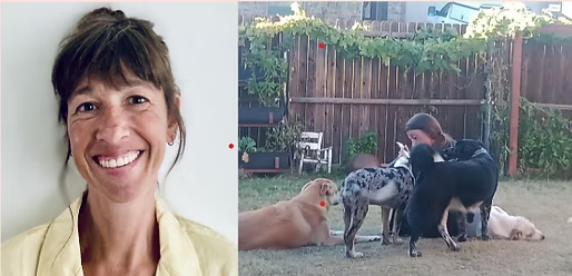 Woman smiling beside a picture of her with dogs in a backyard.