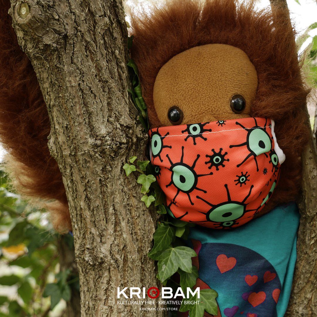 Audery, the Orangutang, modelling a colourful face mask.