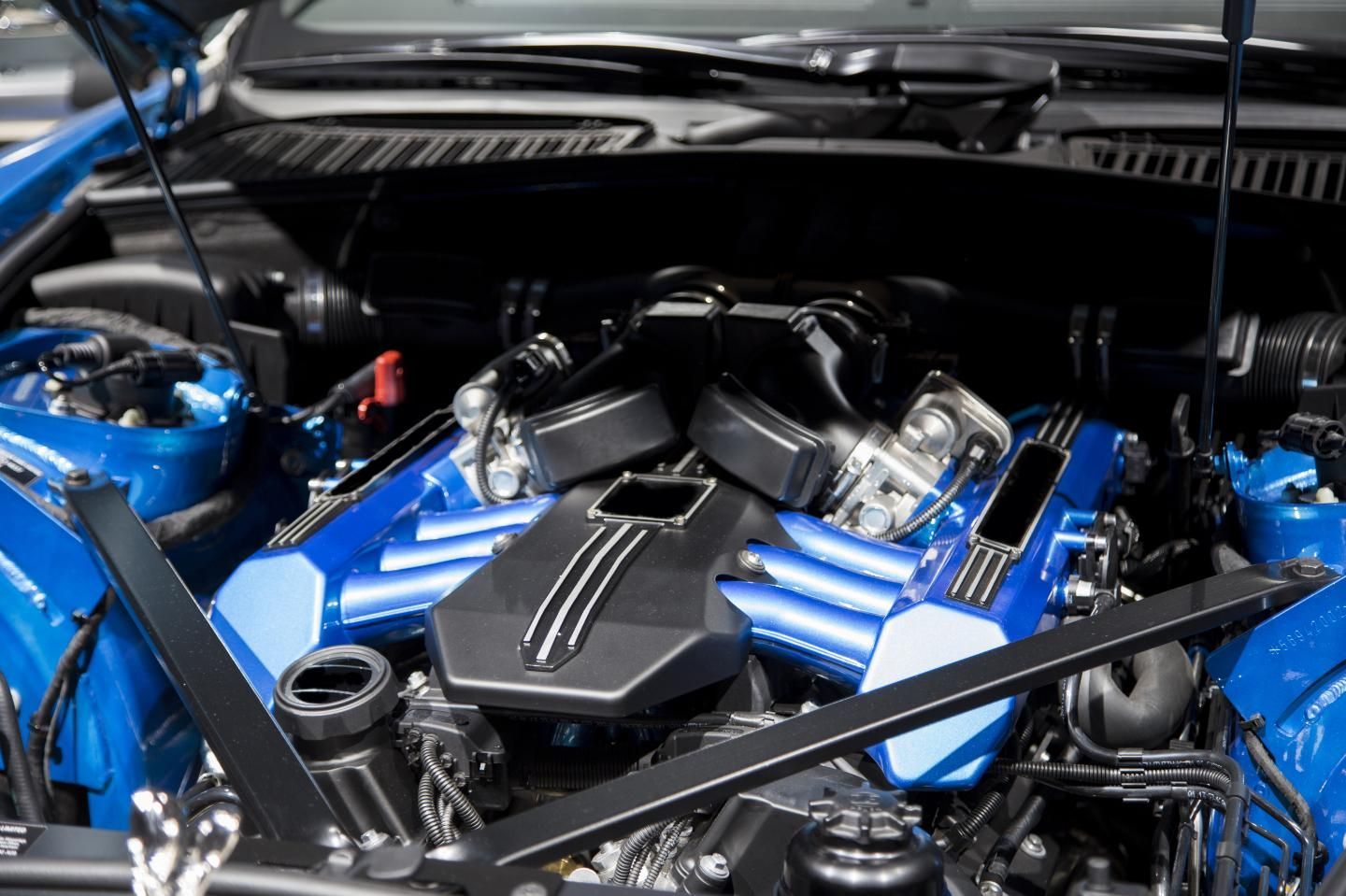 The Engine Of A Blue Sports Car With The Hood Open — McDonald Automotive Services In Islington, NSW