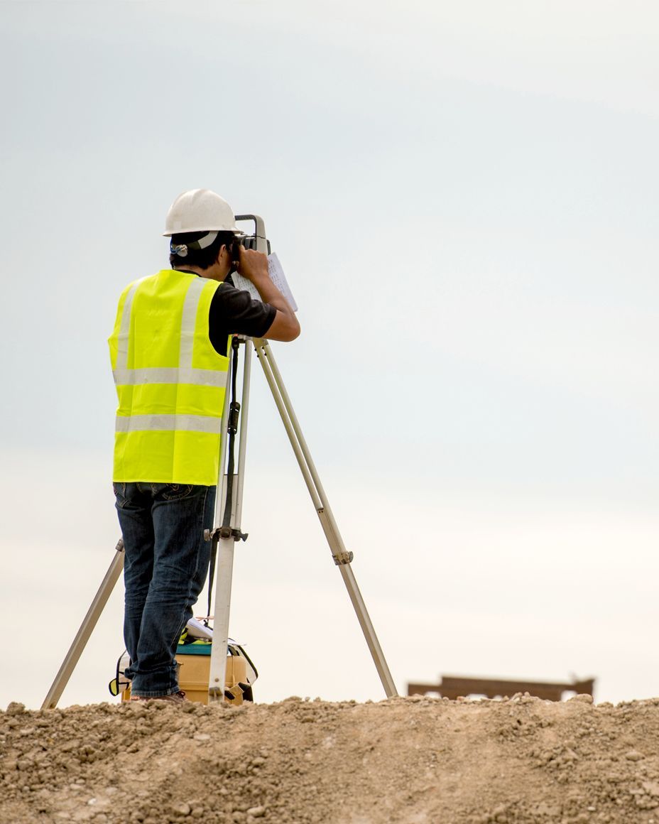 alta surveyor working on commercial development site in little rock