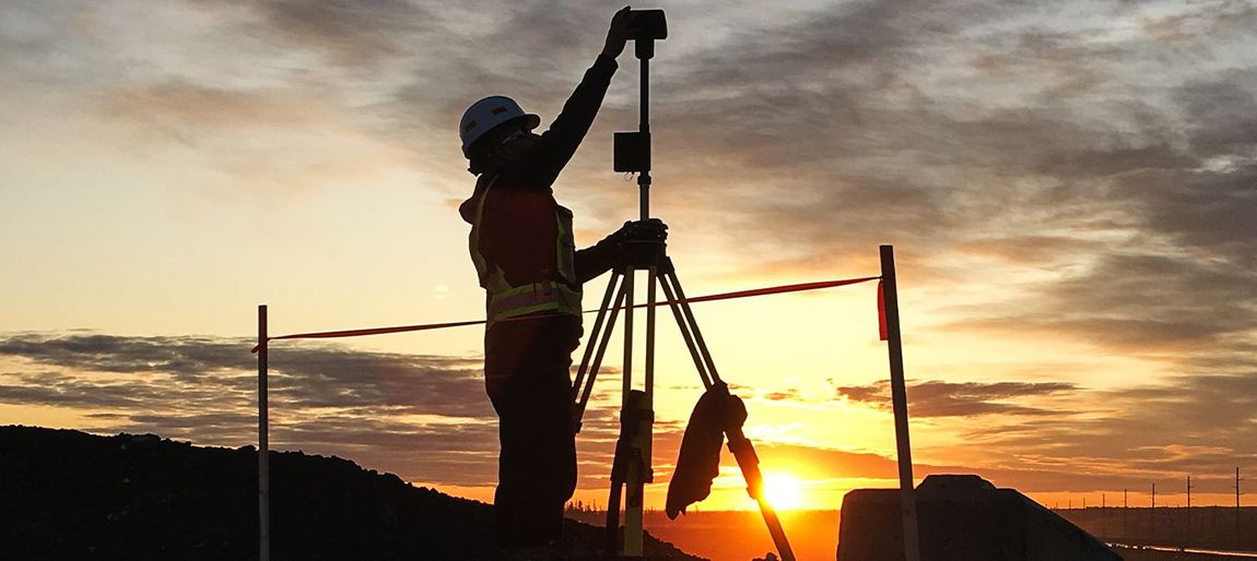 sunrise theodolite with surveyor preparing tool on hill
