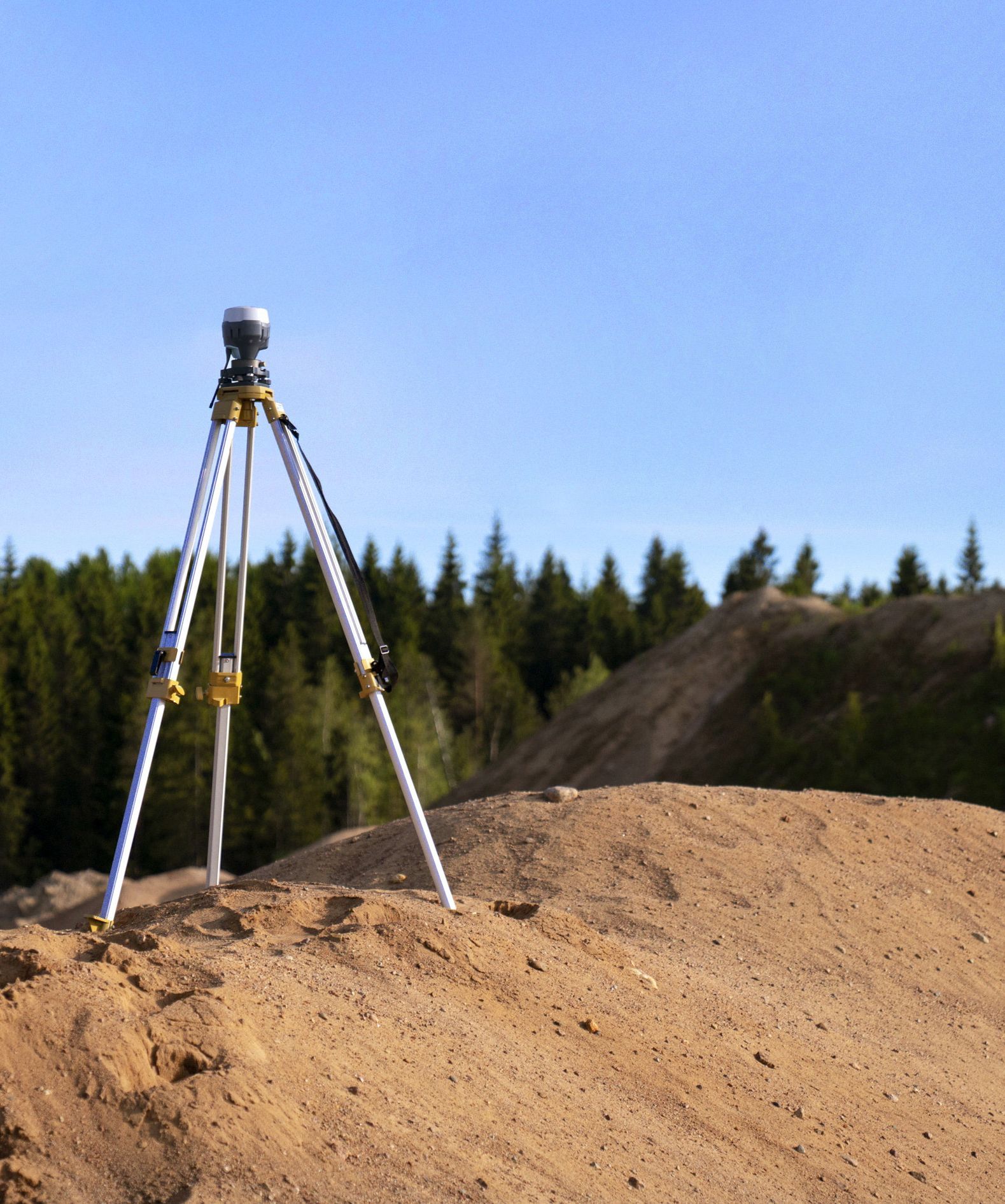 survey tools on a mound of dirt measuring property lines