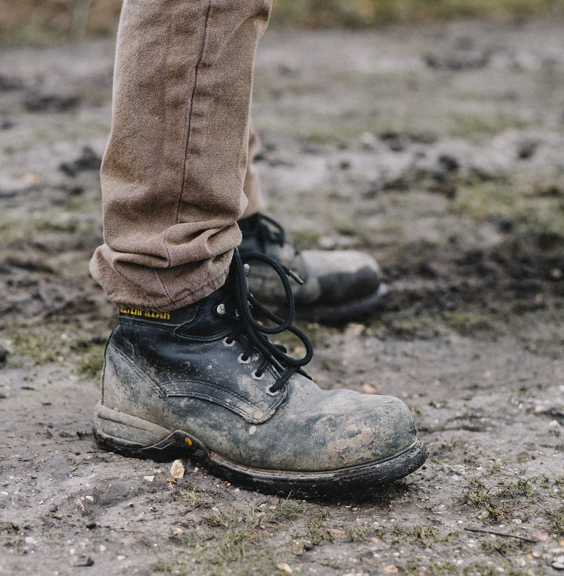 work boots in mud while surveying