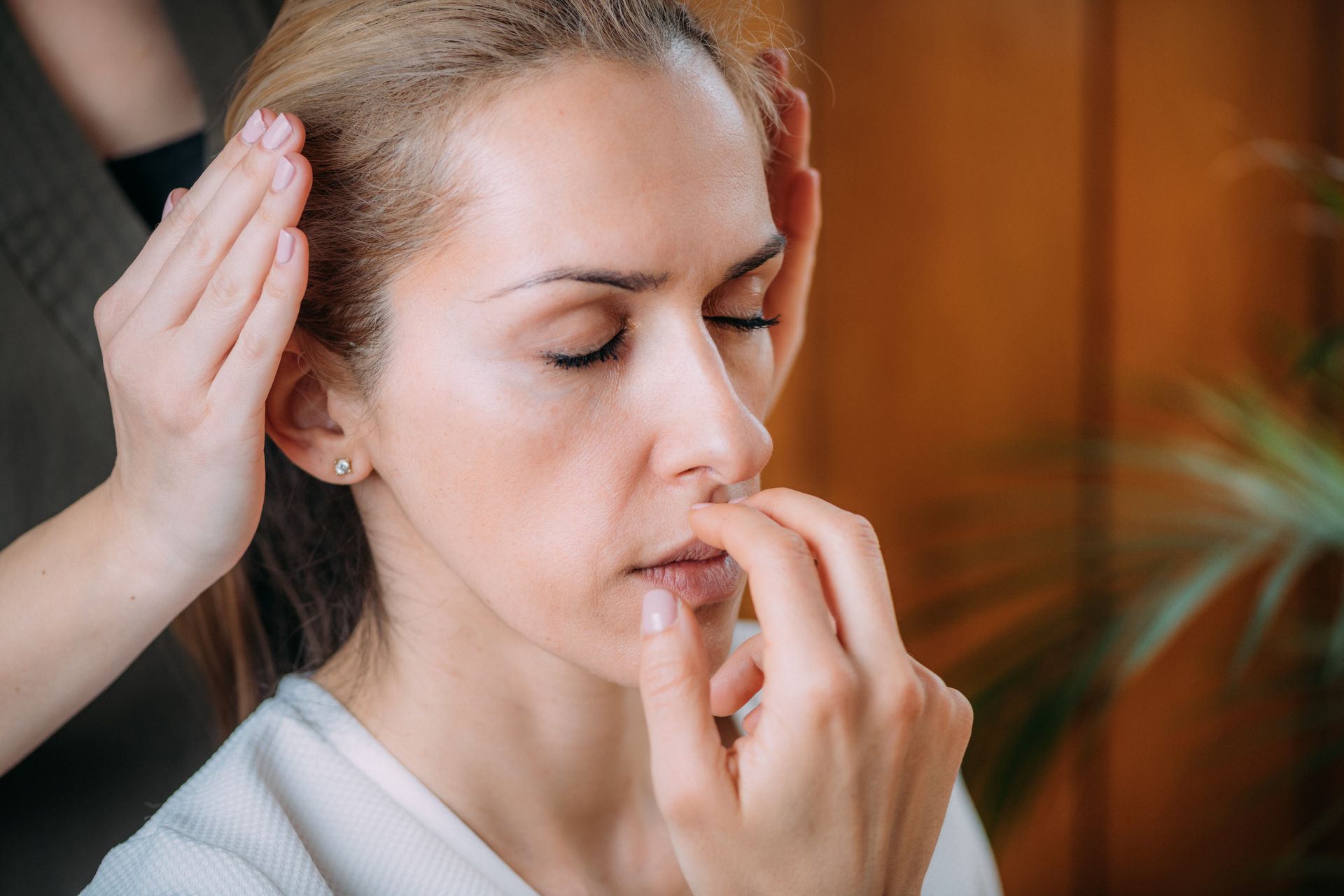 A woman is getting a head massage at a spa.
