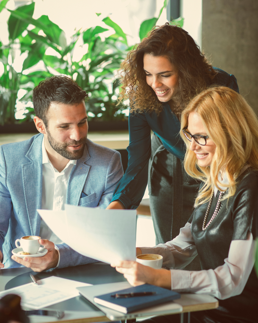 Three business people reviewing forms together.