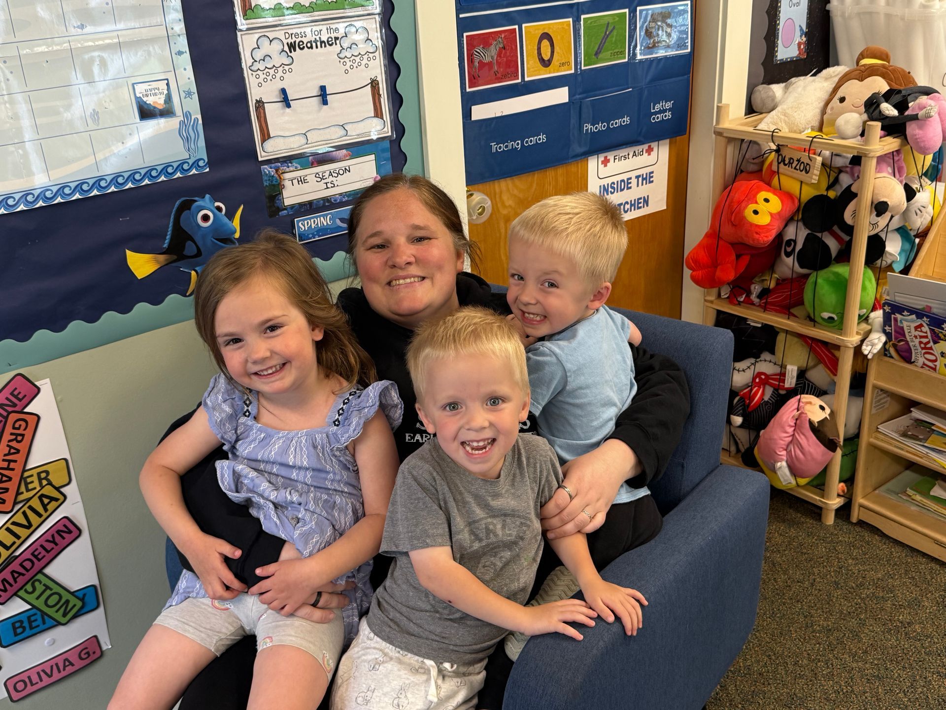 A boy and a girl are sitting on the floor reading books. | Brookline, NH | Scribbles Early Learning