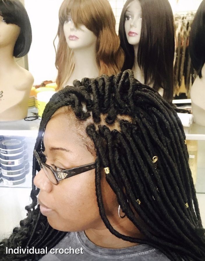 A Woman Is Wearing Glasses And Has A Crocheted Hair Style