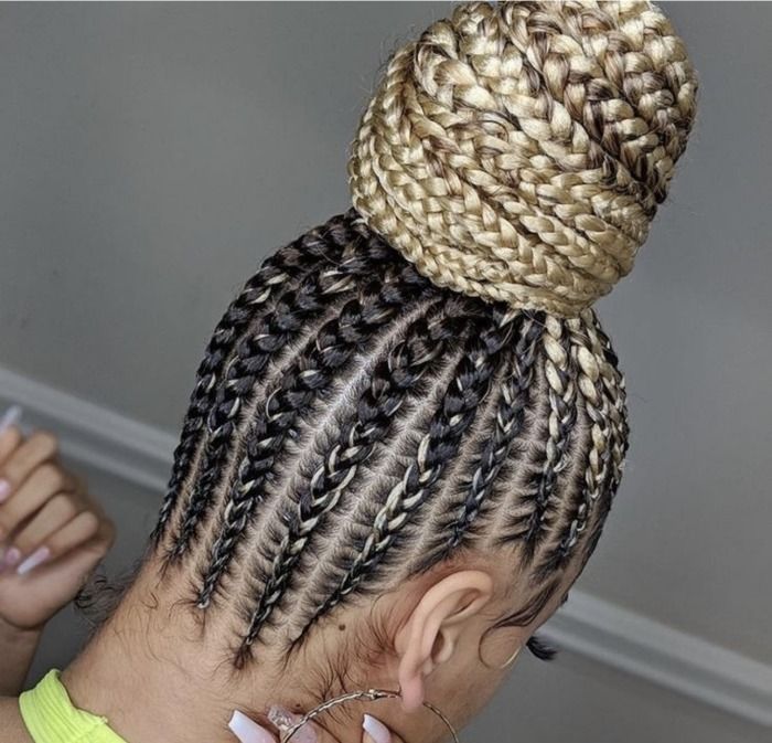 Close-up of cornrows, transitioning to a braided bun with blonde and black hair.