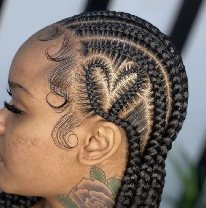 Side profile of a person with braided hair, braids form a heart-shaped pattern on the side of the head.