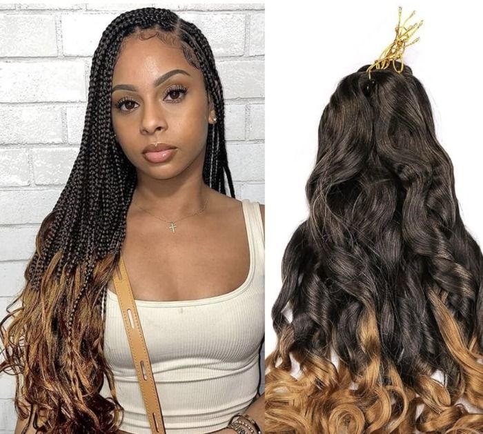 Woman with long black braids and wavy extensions, wearing an orange top.