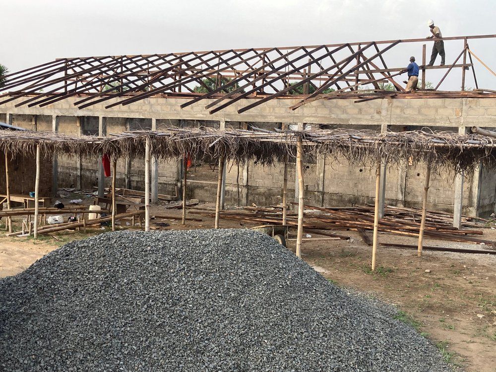 A group of people are working on the roof of a building.