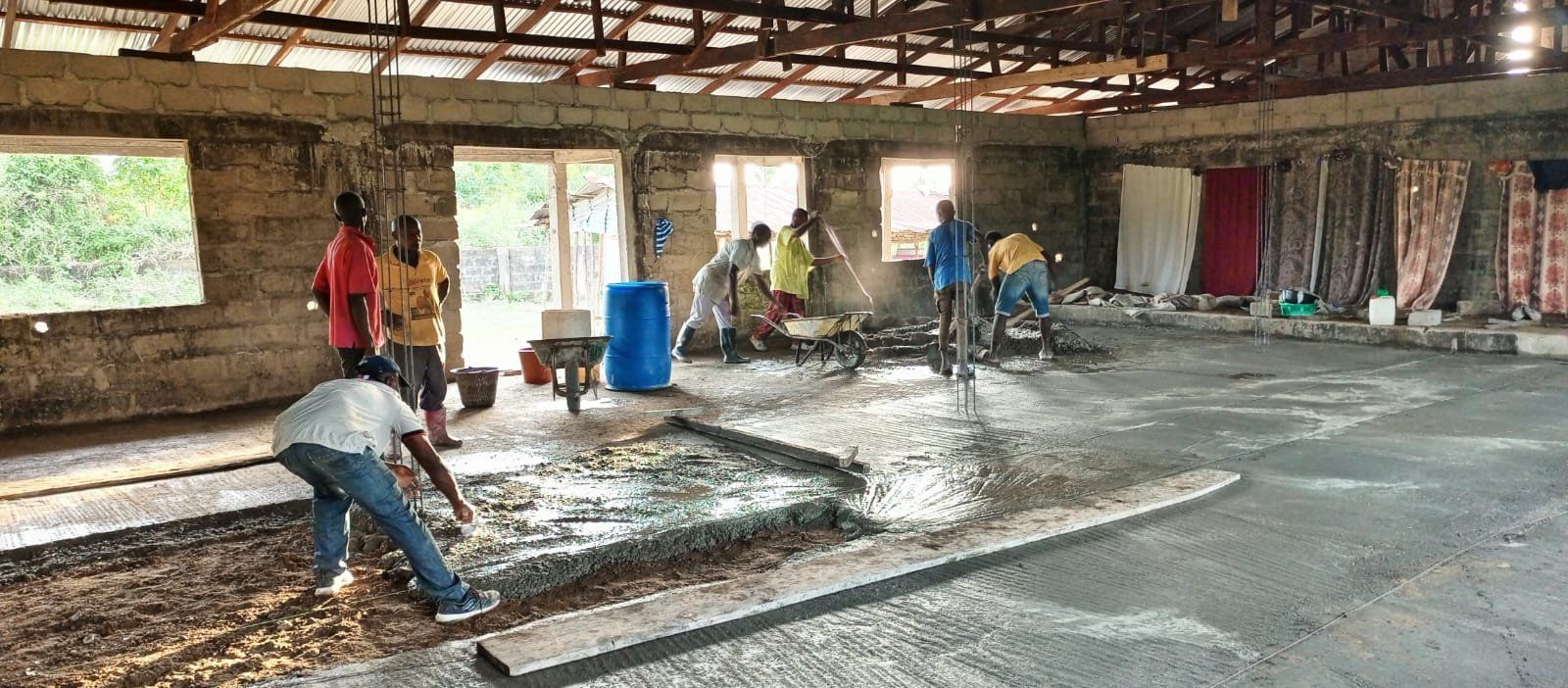 A group of people are working on the floor of a building.