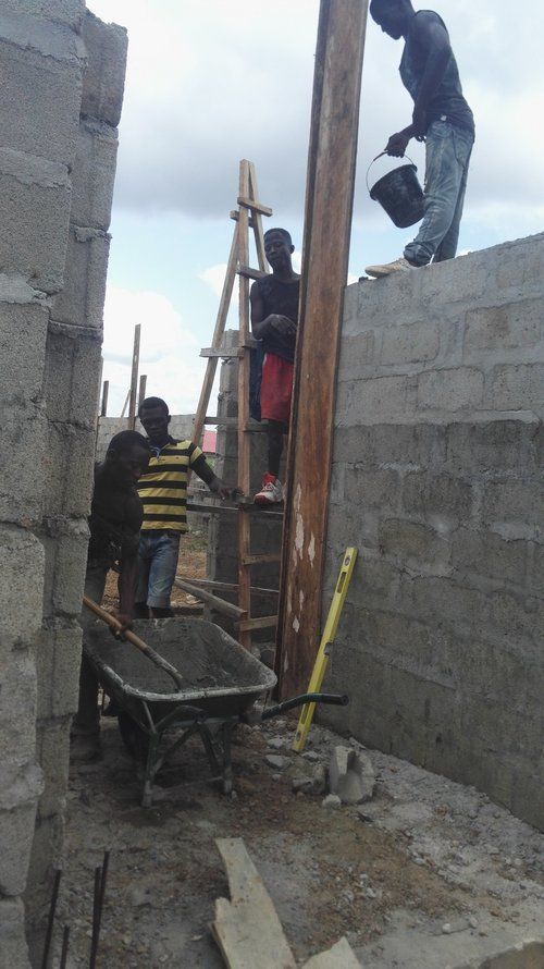 A group of construction workers are working on a building.