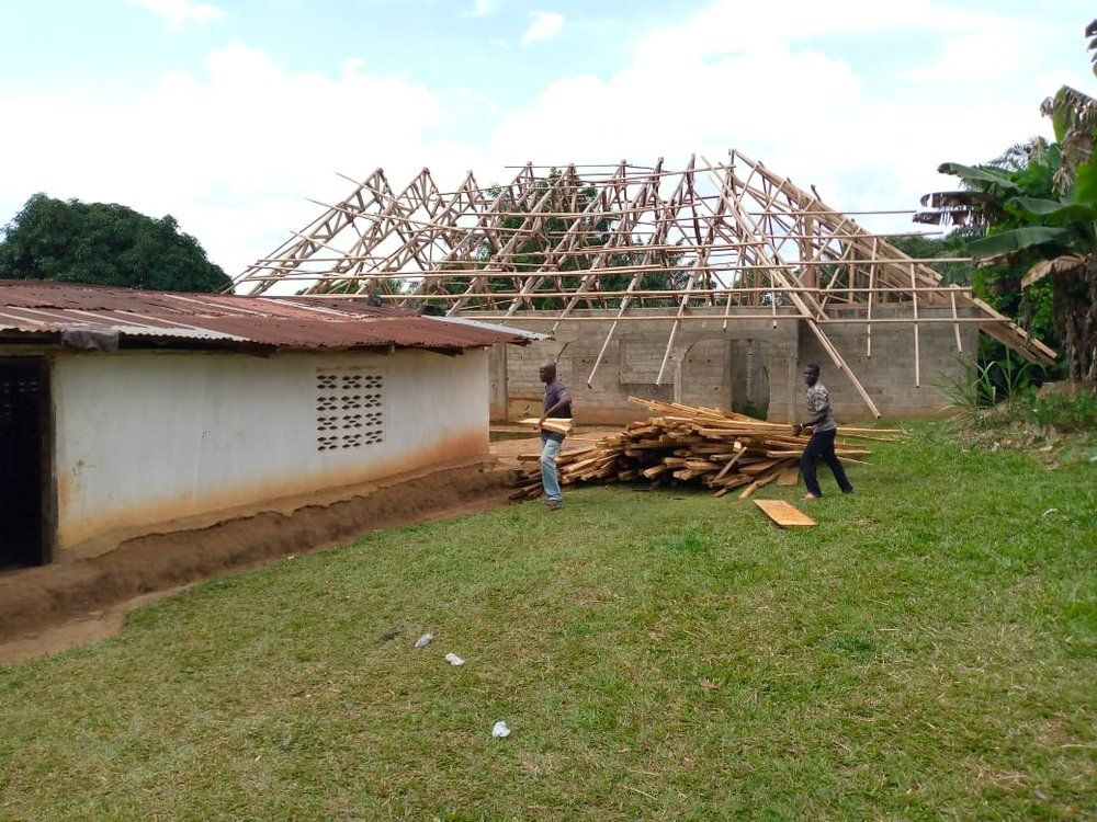 A group of people are standing in front of a building under construction.