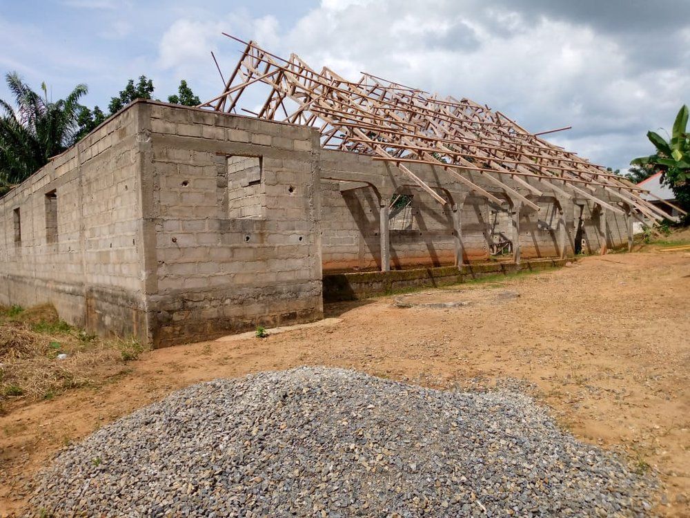 A building under construction with a pile of gravel in front of it