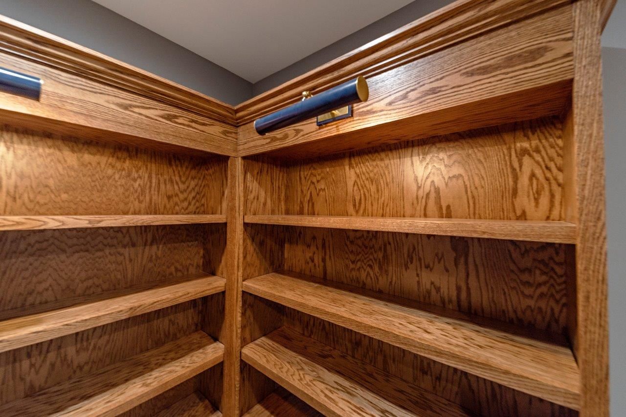 Built-in wooden bookshelves in a corner with installed blue reading lights.