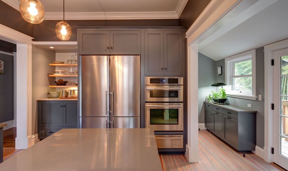 Gray kitchen with stainless steel appliances, cabinets, and a center island.
