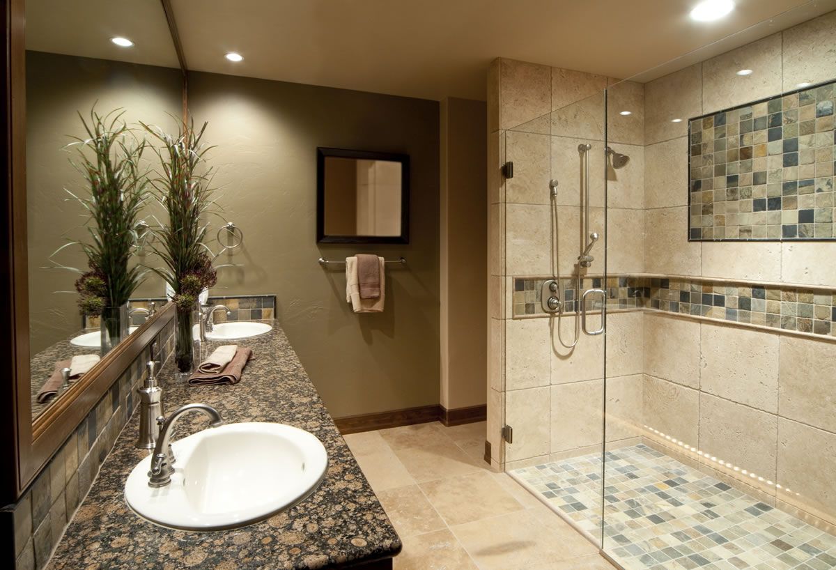 Bathroom with dual sinks, glass shower, and mosaic tile accents.