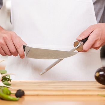 Sharpening Knife in Kitchen — Kansas City, MO — Ambrosi Bros. Cutlery Co