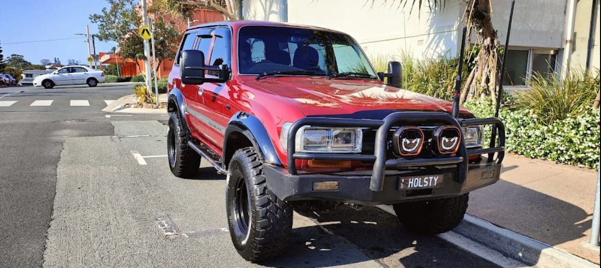 A Red Truck is Parked on the Side of the Road — Brittle's Family Auto Centre in Moffat Beach, QLD