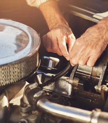 A Man is Working on the Engine of a Car — Brittle's Family Auto Centre in Moffat Beach, QLD