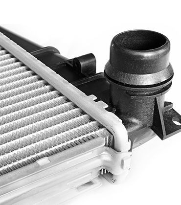 A Close Up of a Radiator With a Hose Attached to It — Brittle's Family Auto Centre in Sunshine Coast, QLD