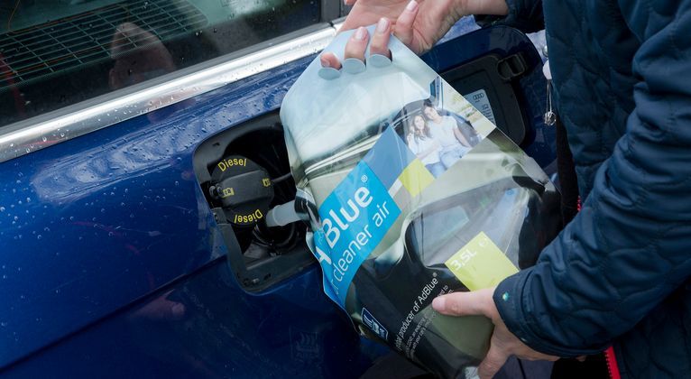 Man pouring Ad Blue product into Aluminium Diesel Tank — A Grade Oils & Batteries In Wodonga VIC