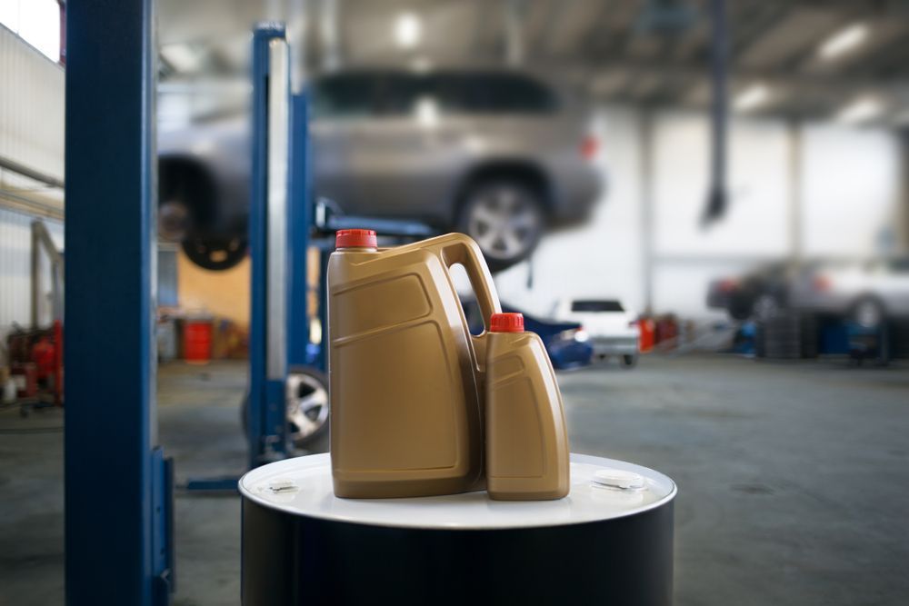 Two bottles of motor oil in car shop — A Grade Oils & Batteries In Wagga Wagga NSW