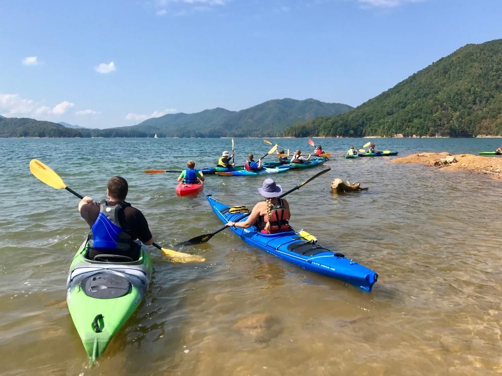 A group of people are kayaking on a lake.