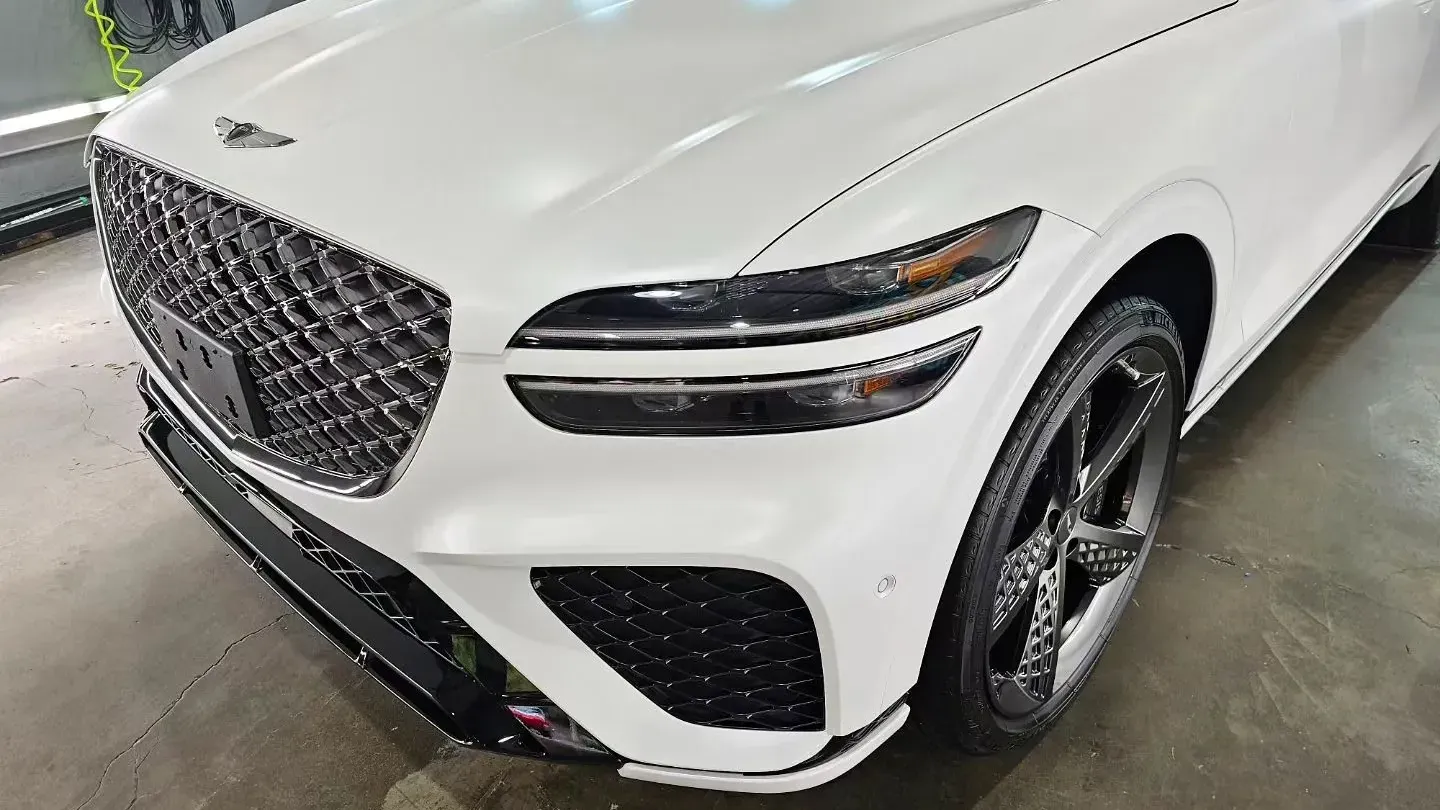 A white car is parked in a garage.