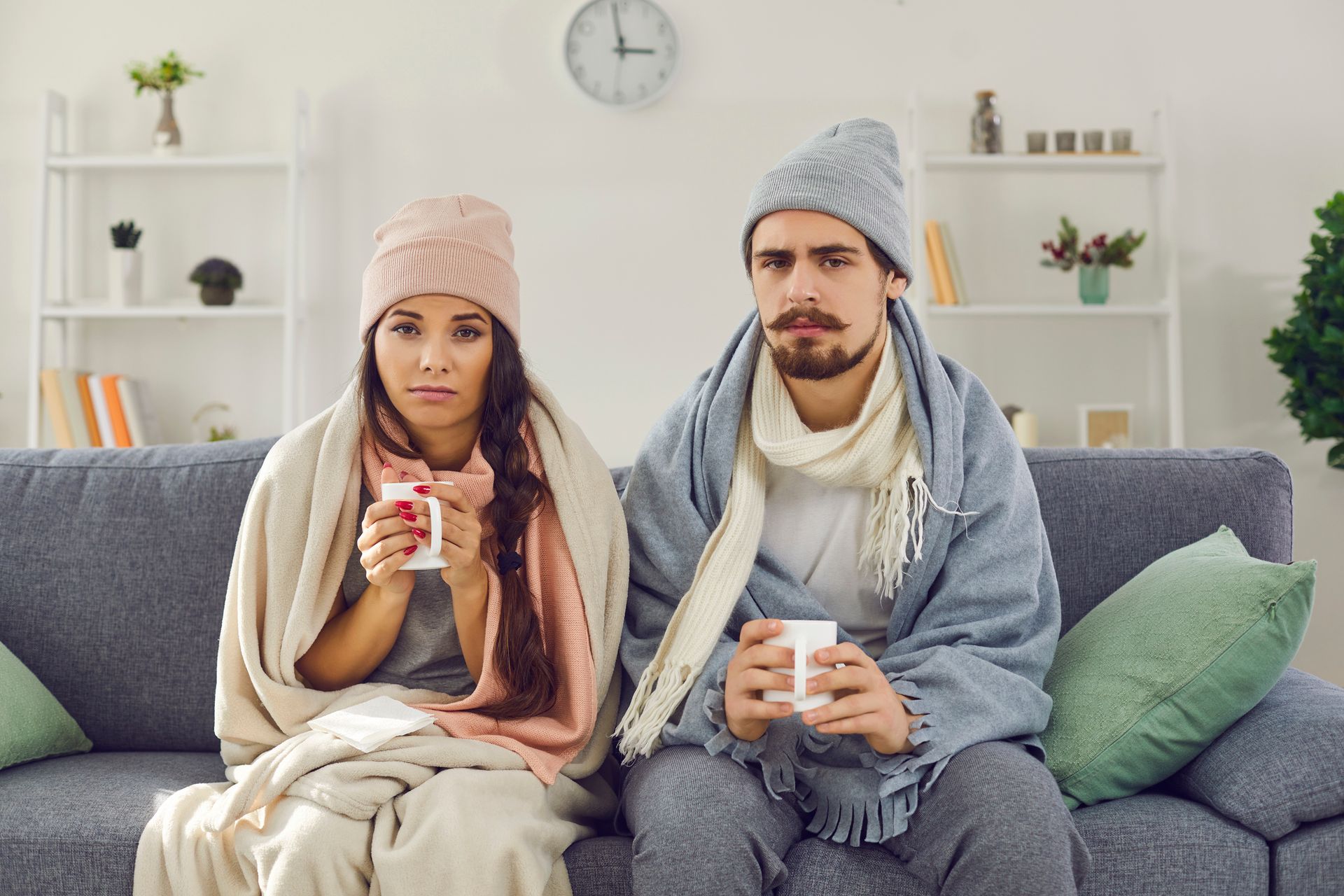 An upset young couple having problems with central heating and needs Arctic Fox Cooling services.