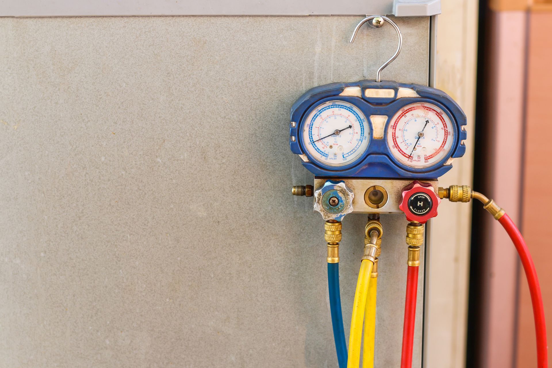 A professional HVAC technician working on an air conditioning unit, showing upcoming refrigerant.