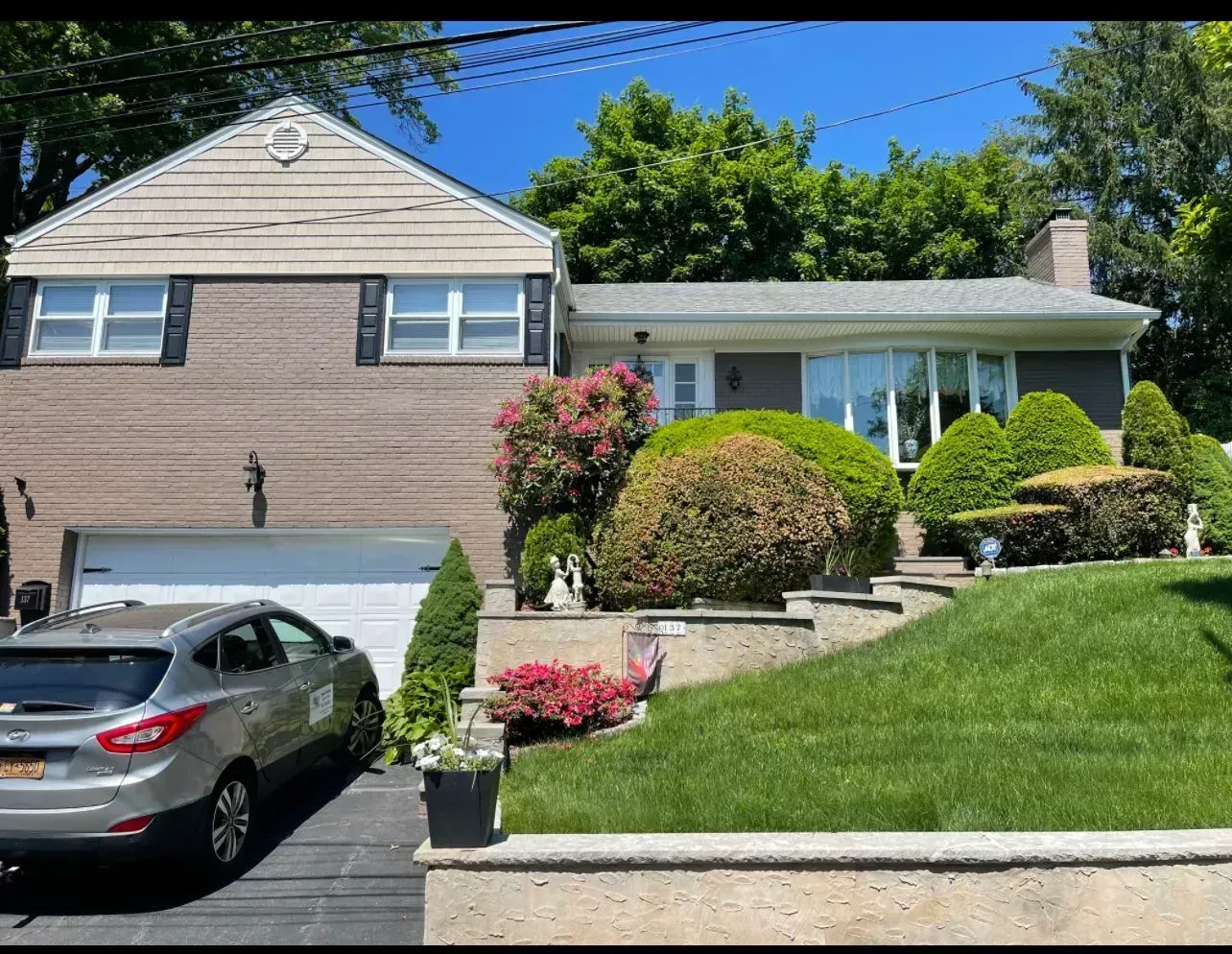 A house with a car parked in front of it