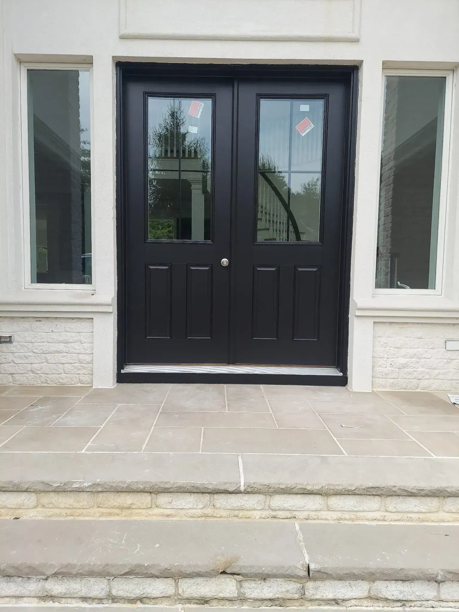The front door of a building with a black door