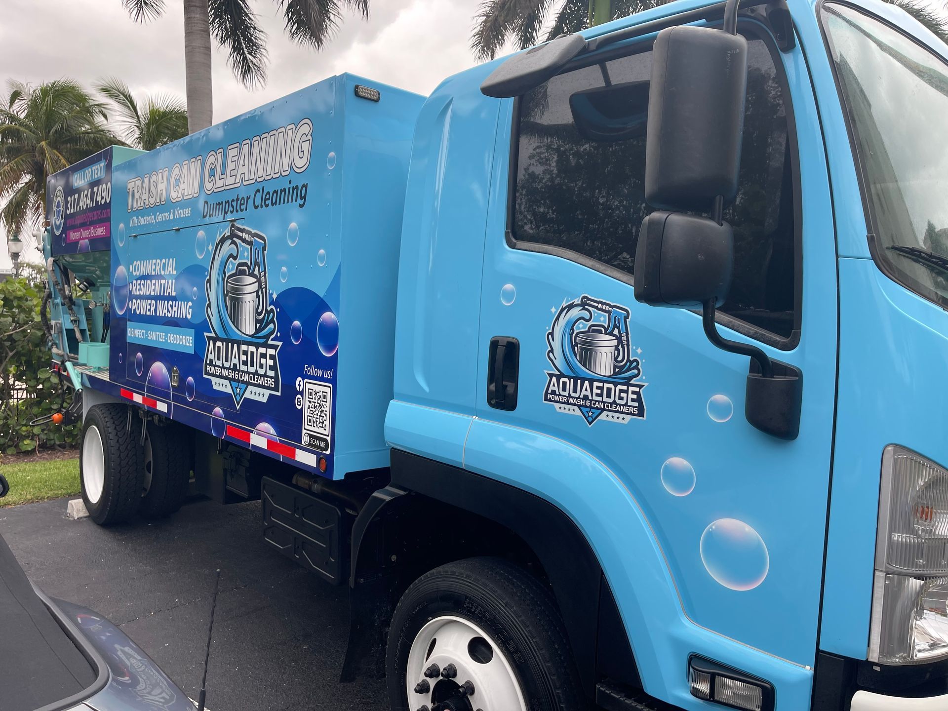 A blue truck is parked on the side of the road.