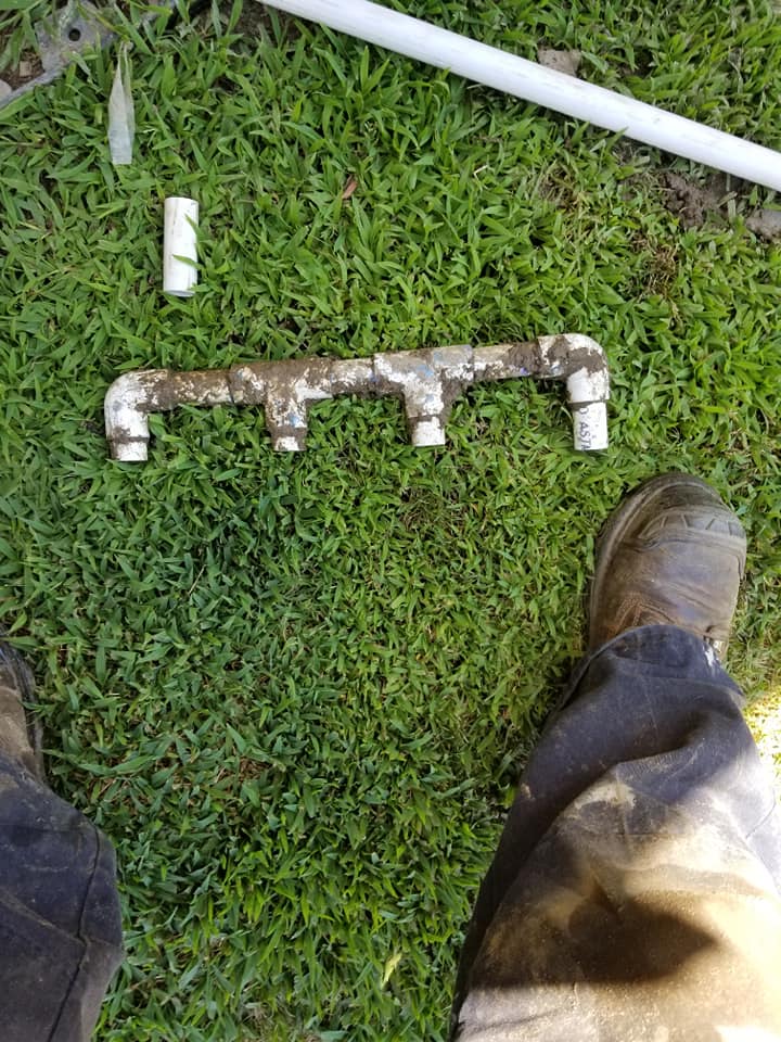 Old pipe next to foot — Anaheim, CA — SG Gardening Landscape & Tree Services