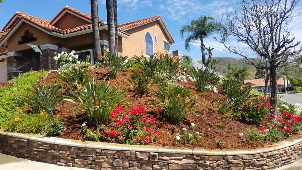 A house with a lot of flowers in front of it