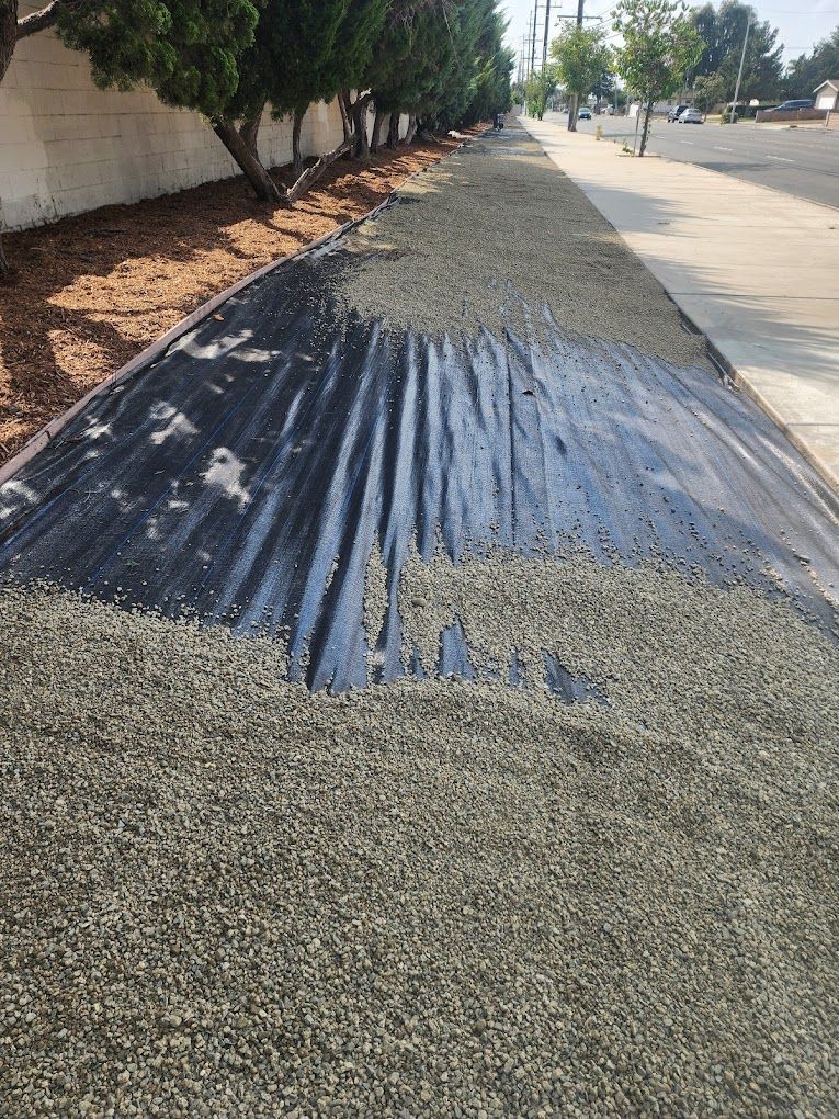 A pile of gravel is sitting on the side of the road.
