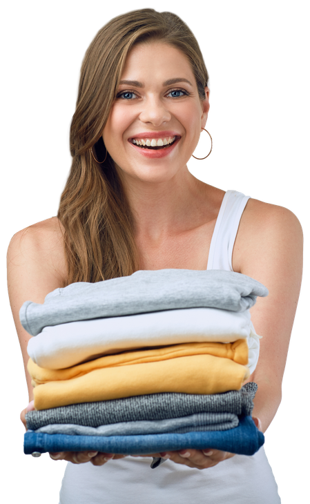 Smiling young holding stack of folded clothes