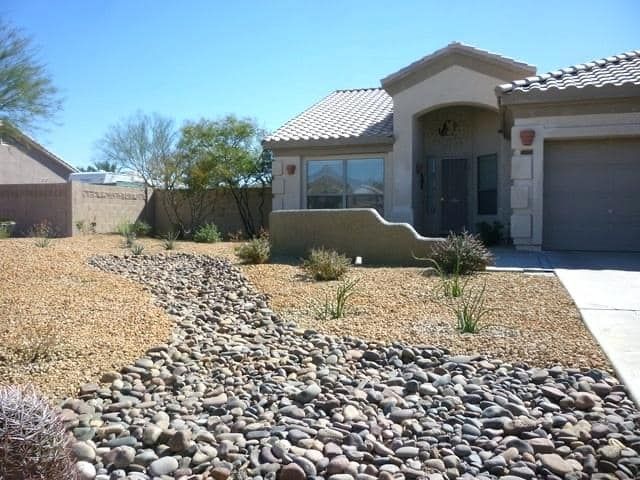 A house with a lot of rocks in front of it