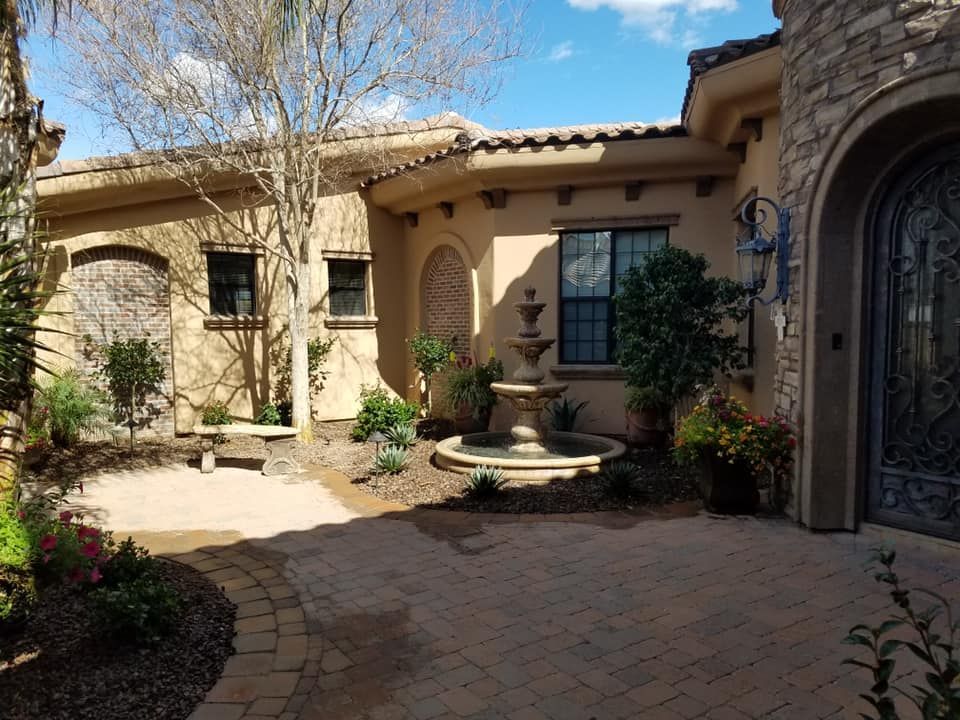 A large house with a fountain in front of it