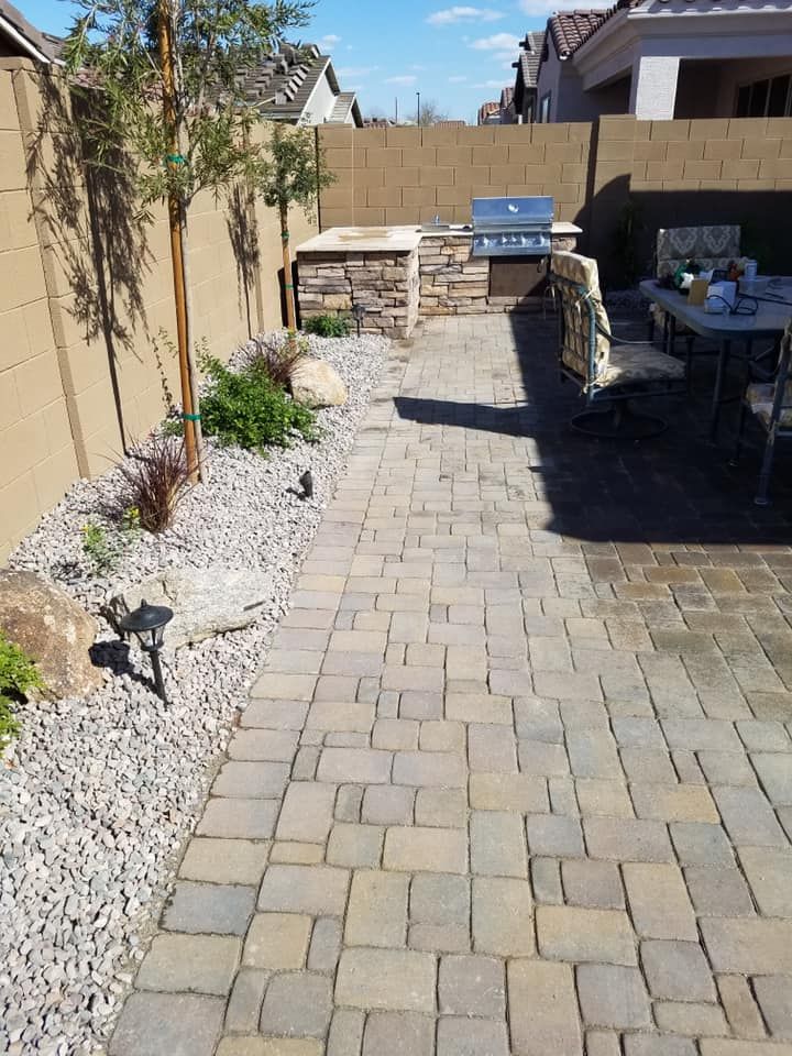 A patio with a table and chairs and a grill