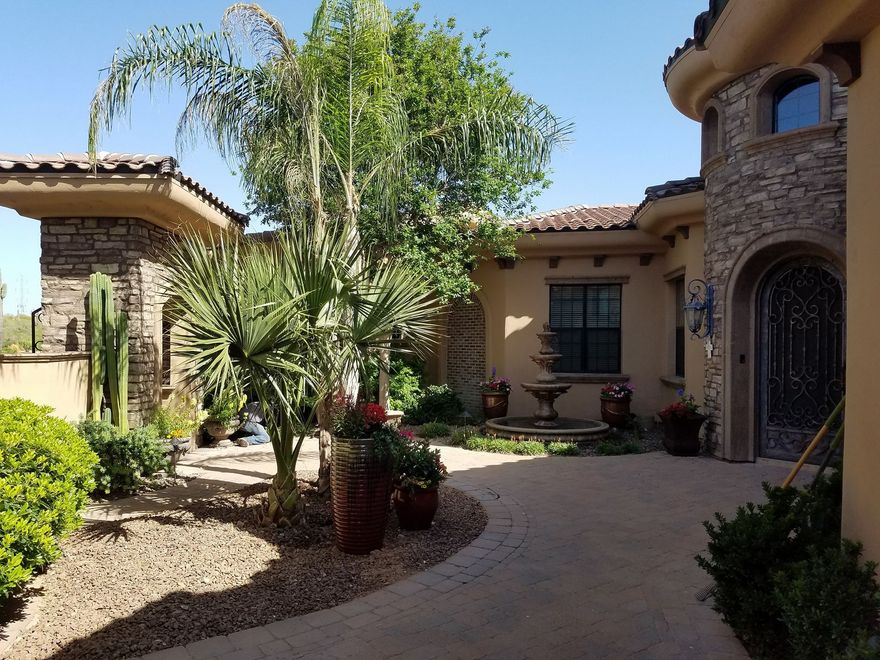 A large house with a lot of plants in front of it
