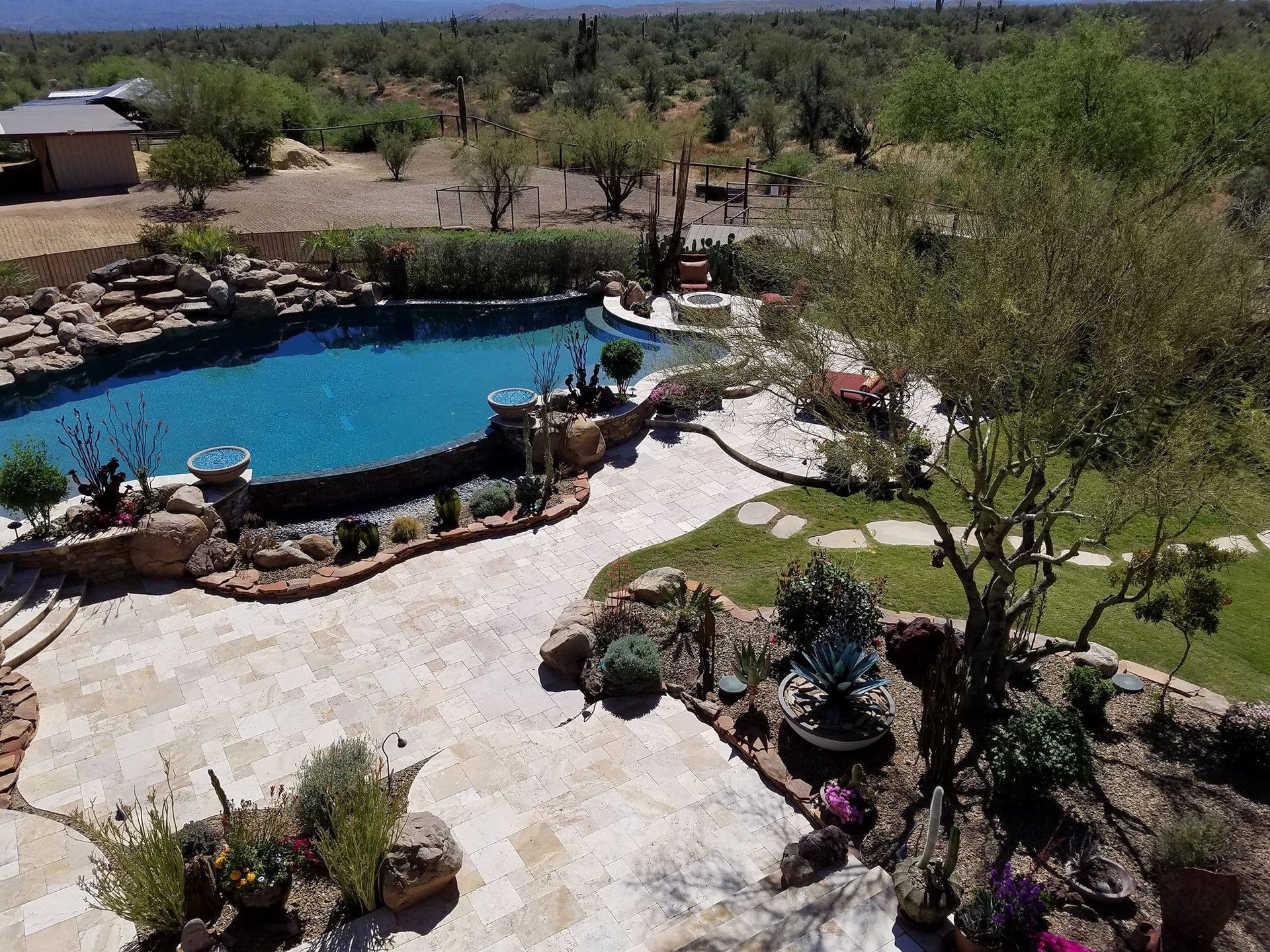 An aerial view of a large swimming pool in a backyard