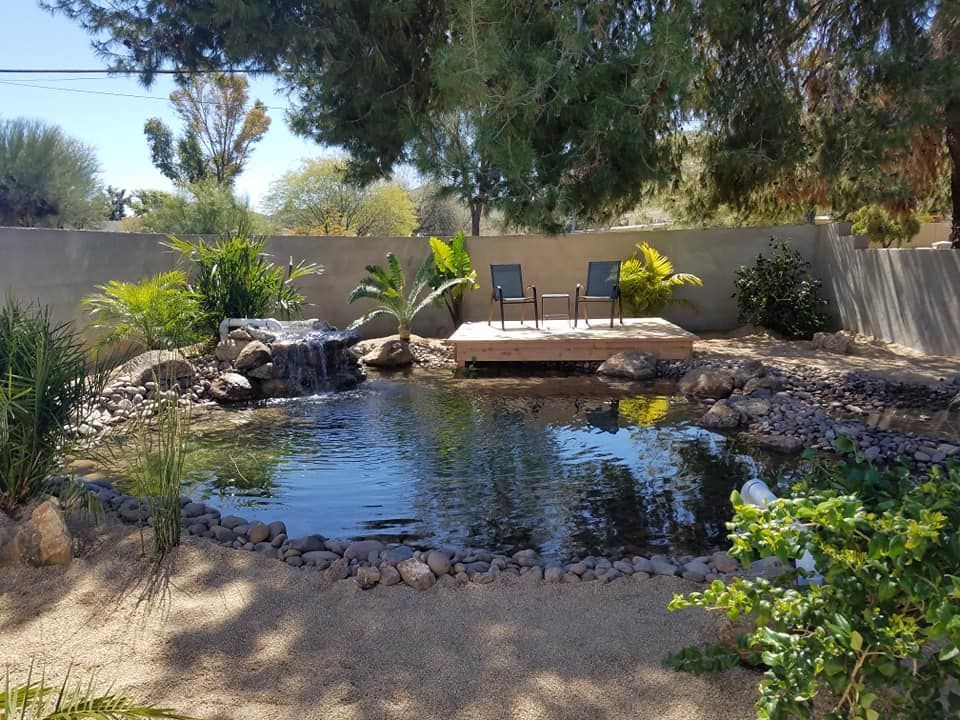 A pond with a waterfall in the middle of it