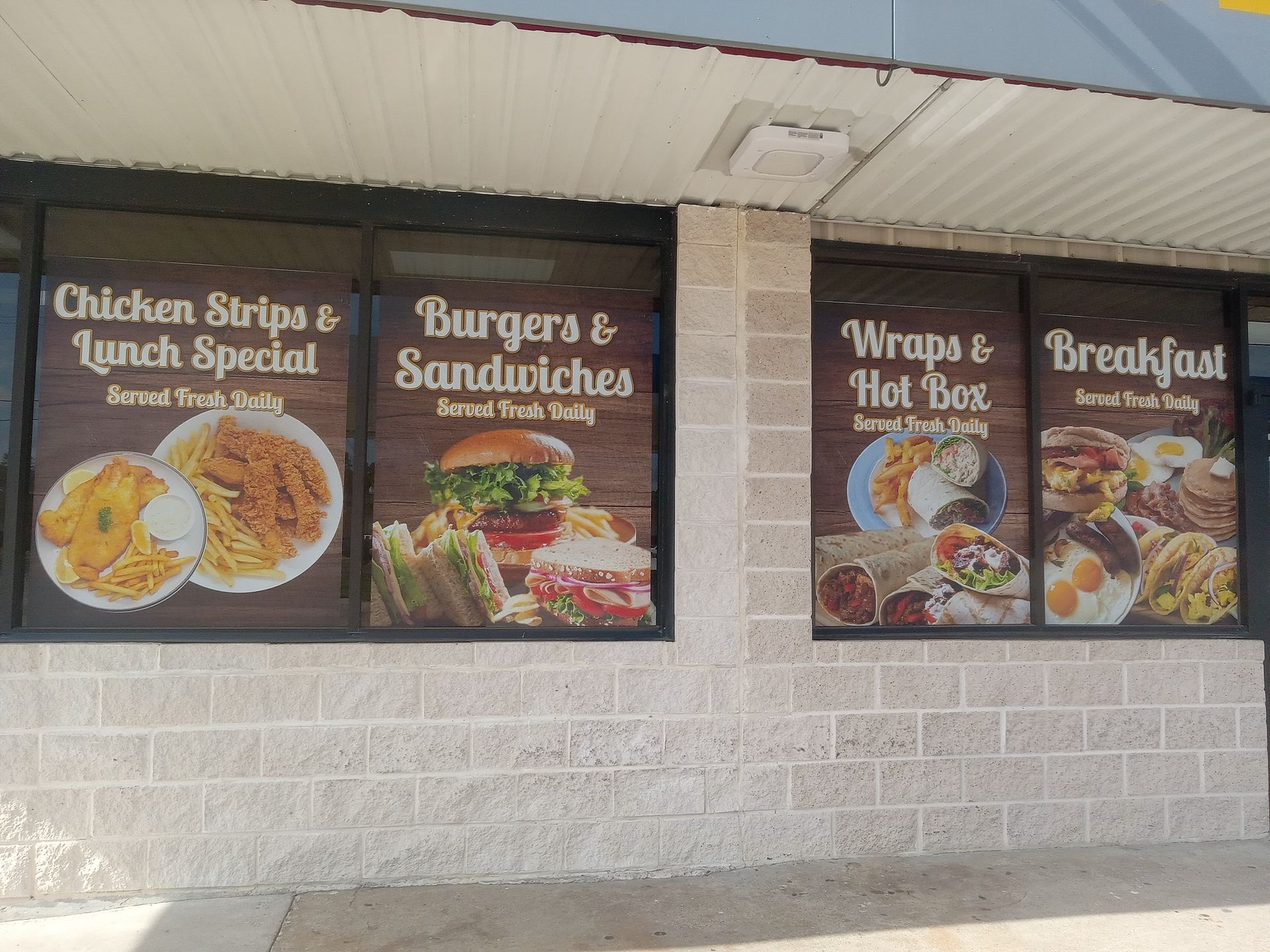 A fast food restaurant offers chicken strips and lunch specials burgers and sandwiches wraps and hot boxes and breakfast.