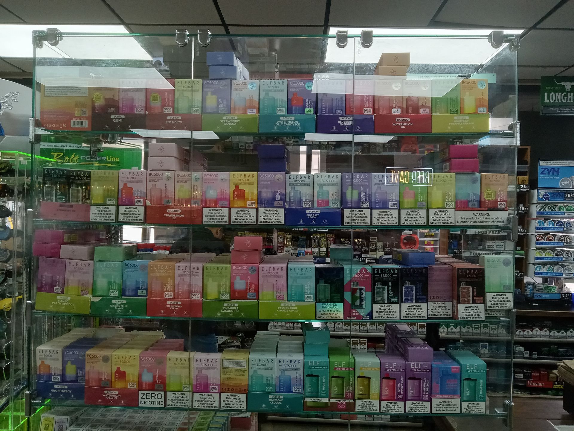 A display case filled with lots of perfume boxes in a store.