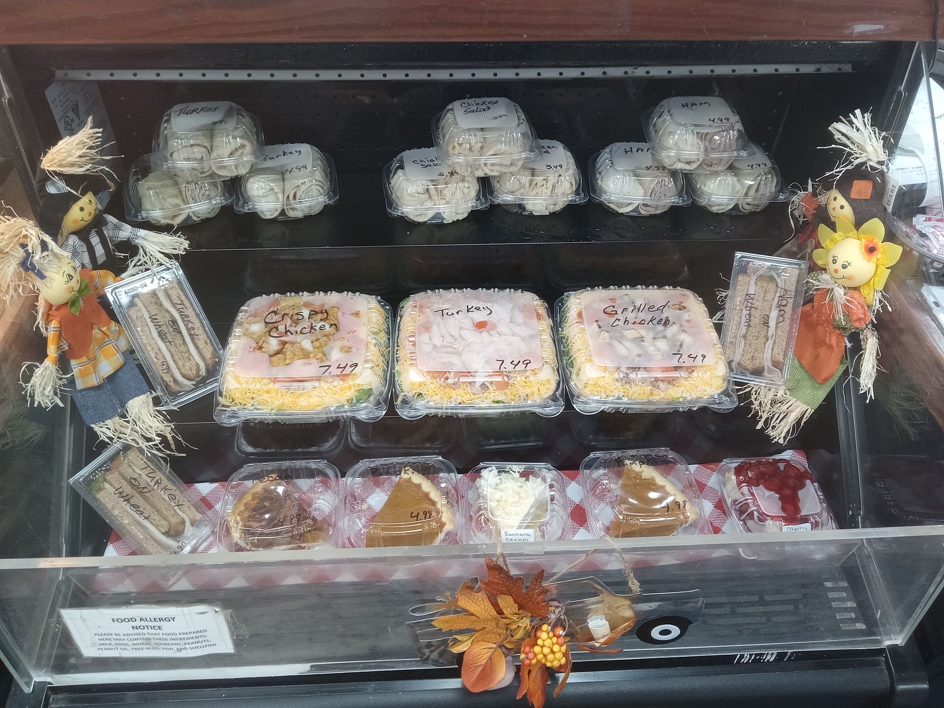 A display case filled with a variety of cakes and pastries.