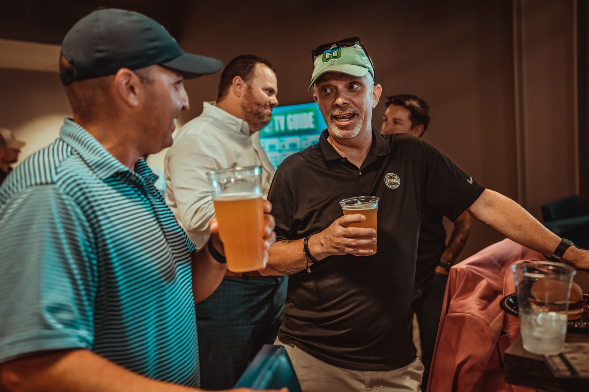 A group of dads are standing next to each other holding beer mugs.